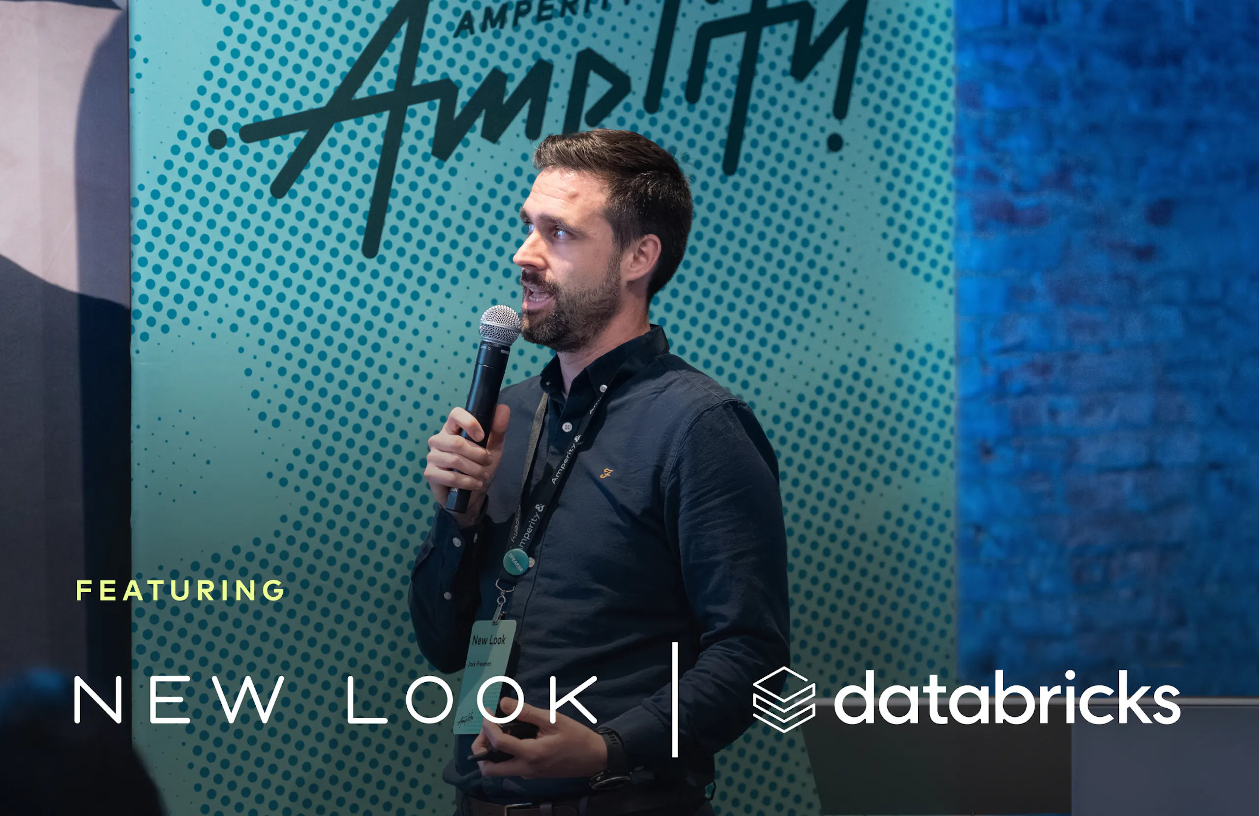 Jack Freeman, New Look, speaking into a handheld mic onstage at Amplify 2026.
