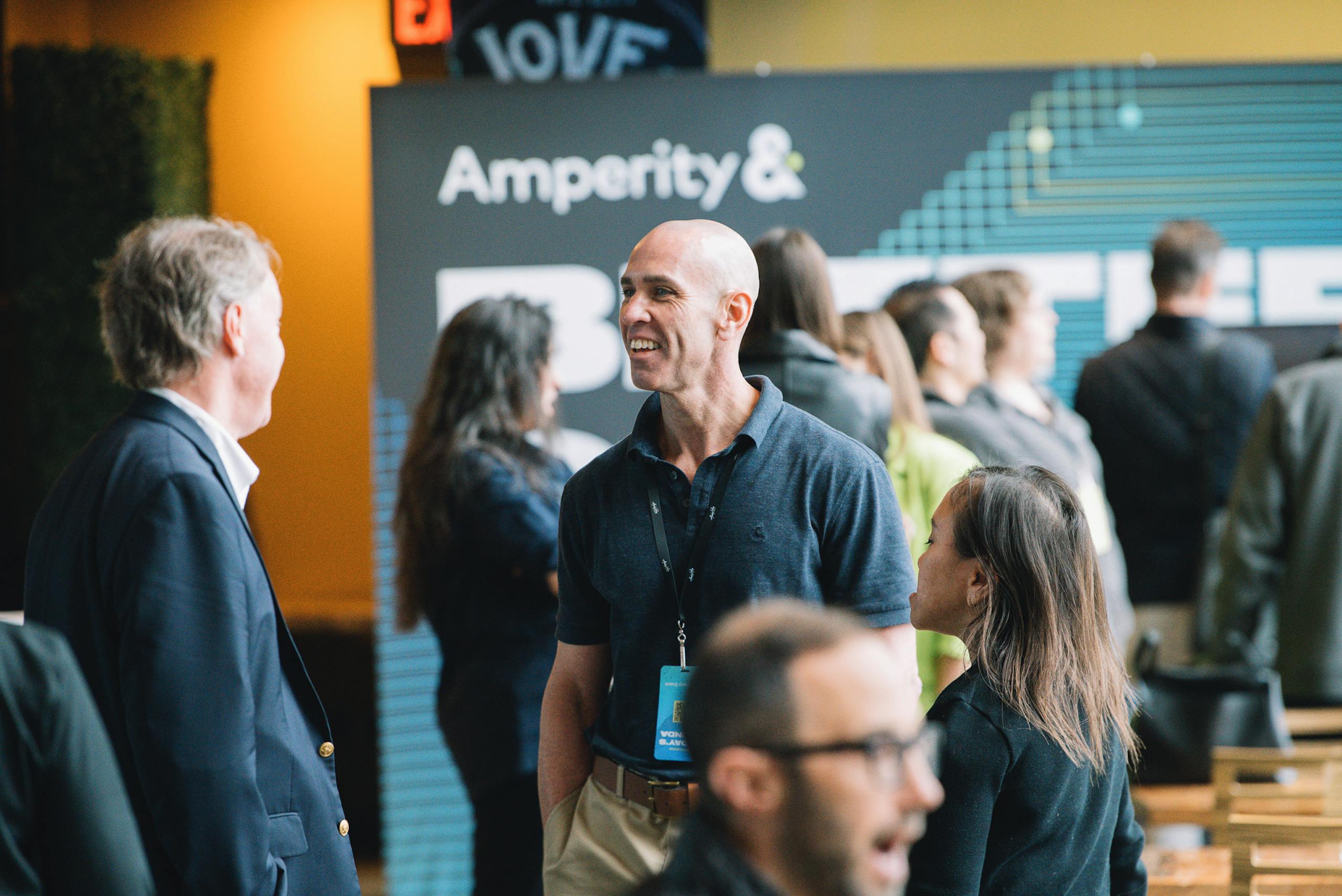 Two people chatting amiably at Amplify, Amperity's annual summit