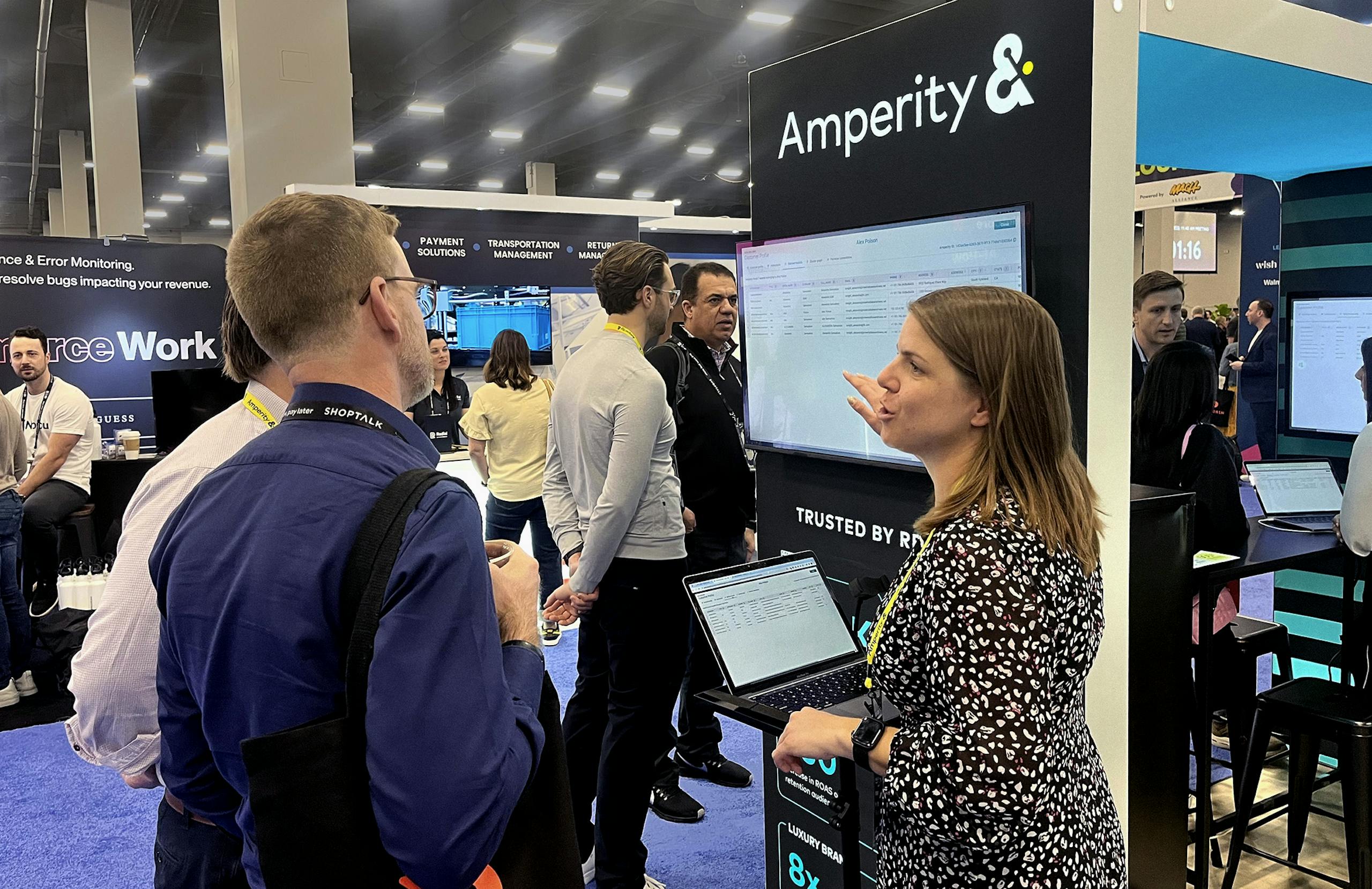 Shoptalk attendees watching a demo at the Amperity booth