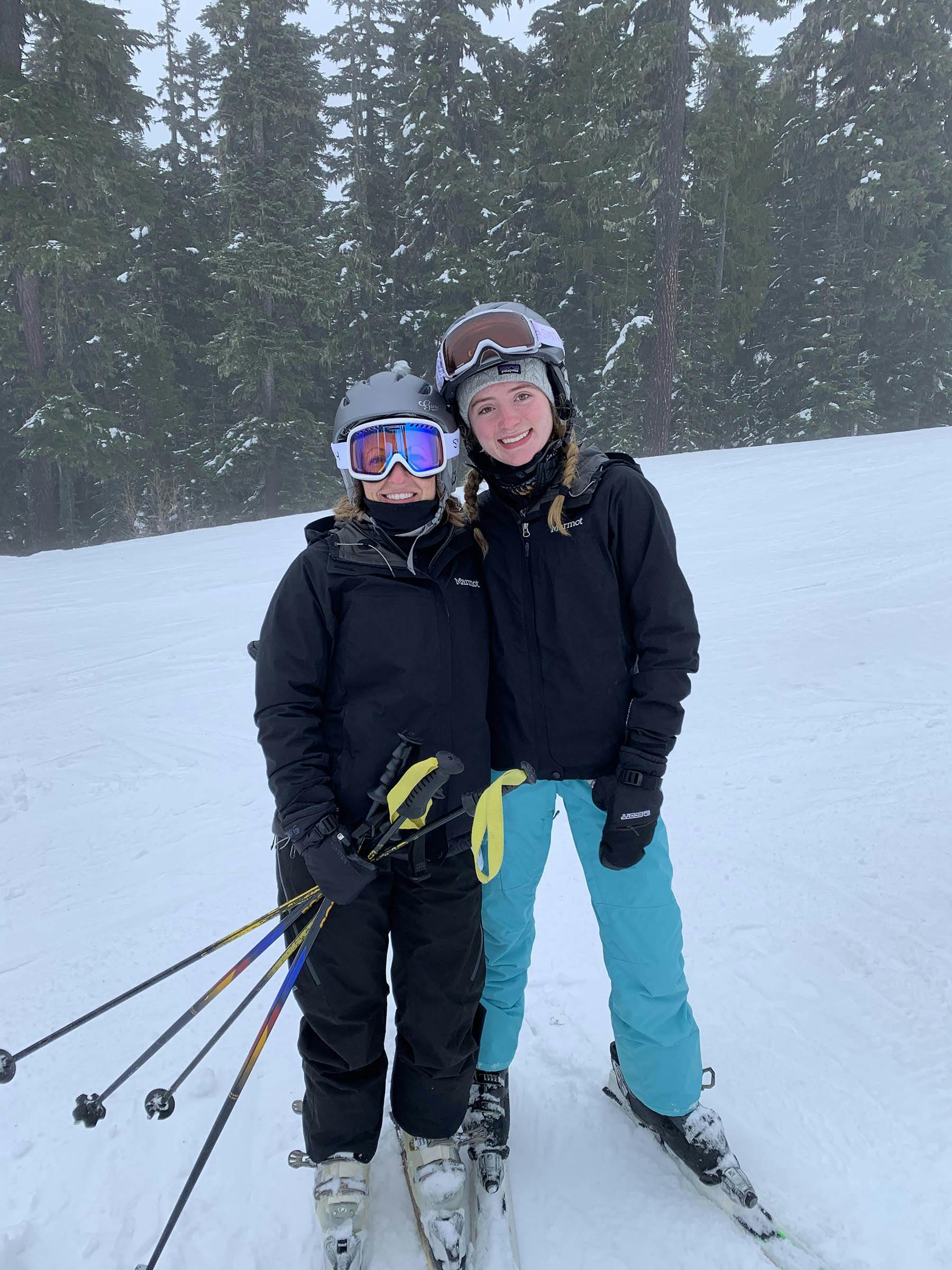 Melanie Allen and friend posing with skis