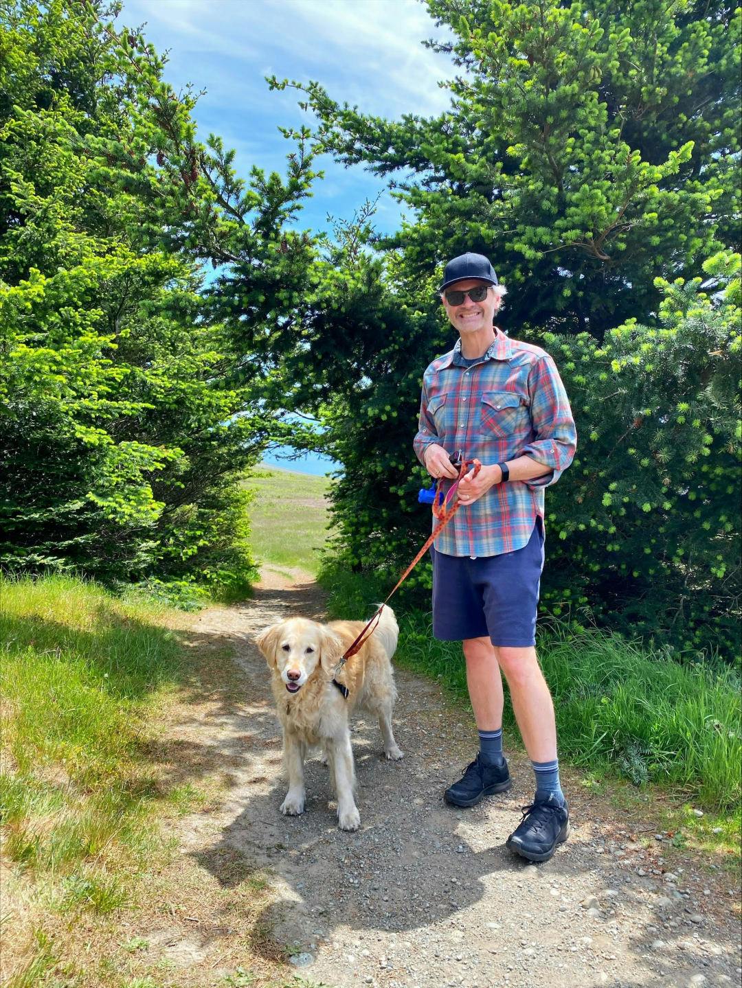 Brian Knollenberg on a hike with his golden retriever