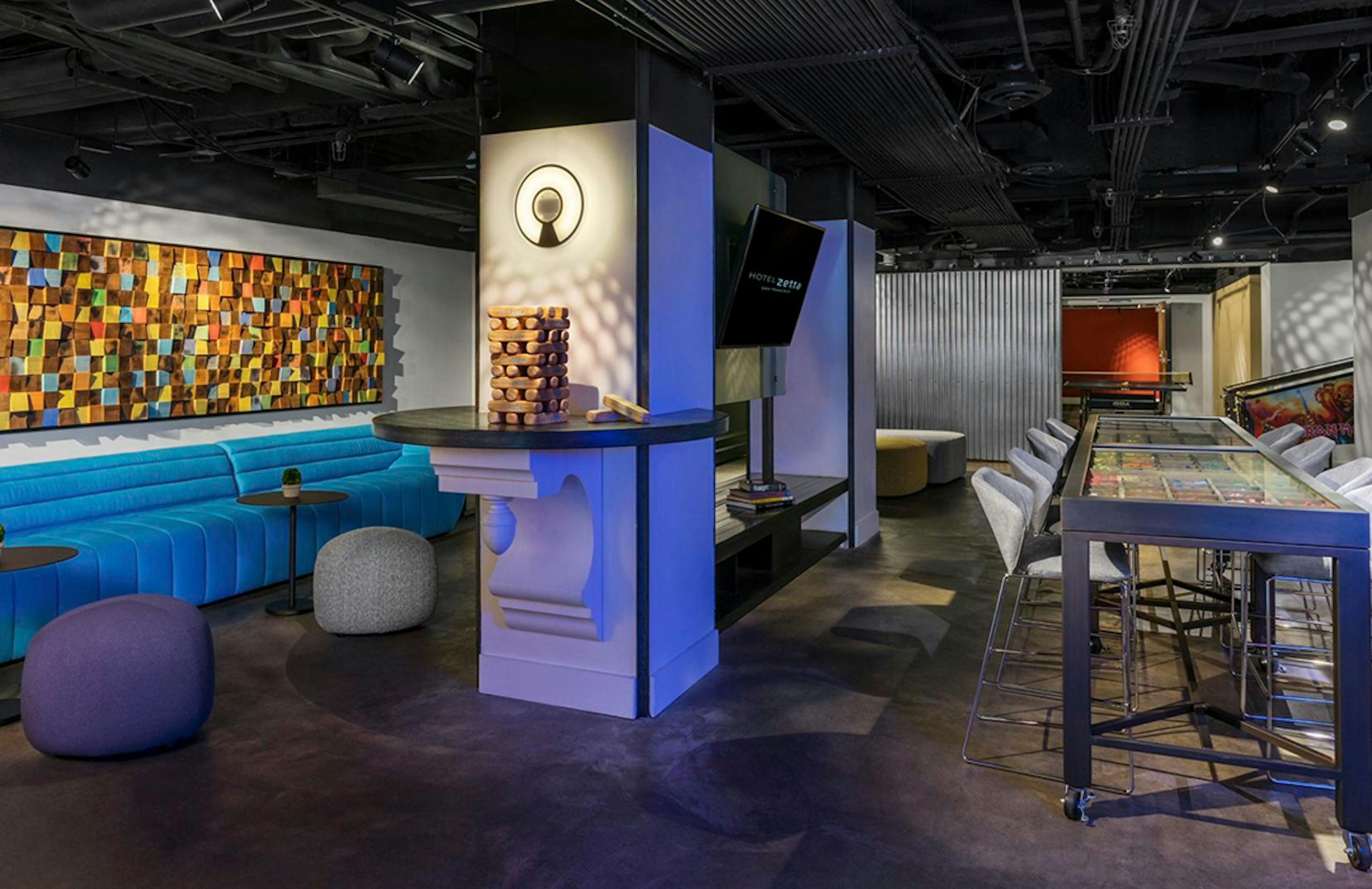 Play room with large jenga tower, bar seating, and booths
