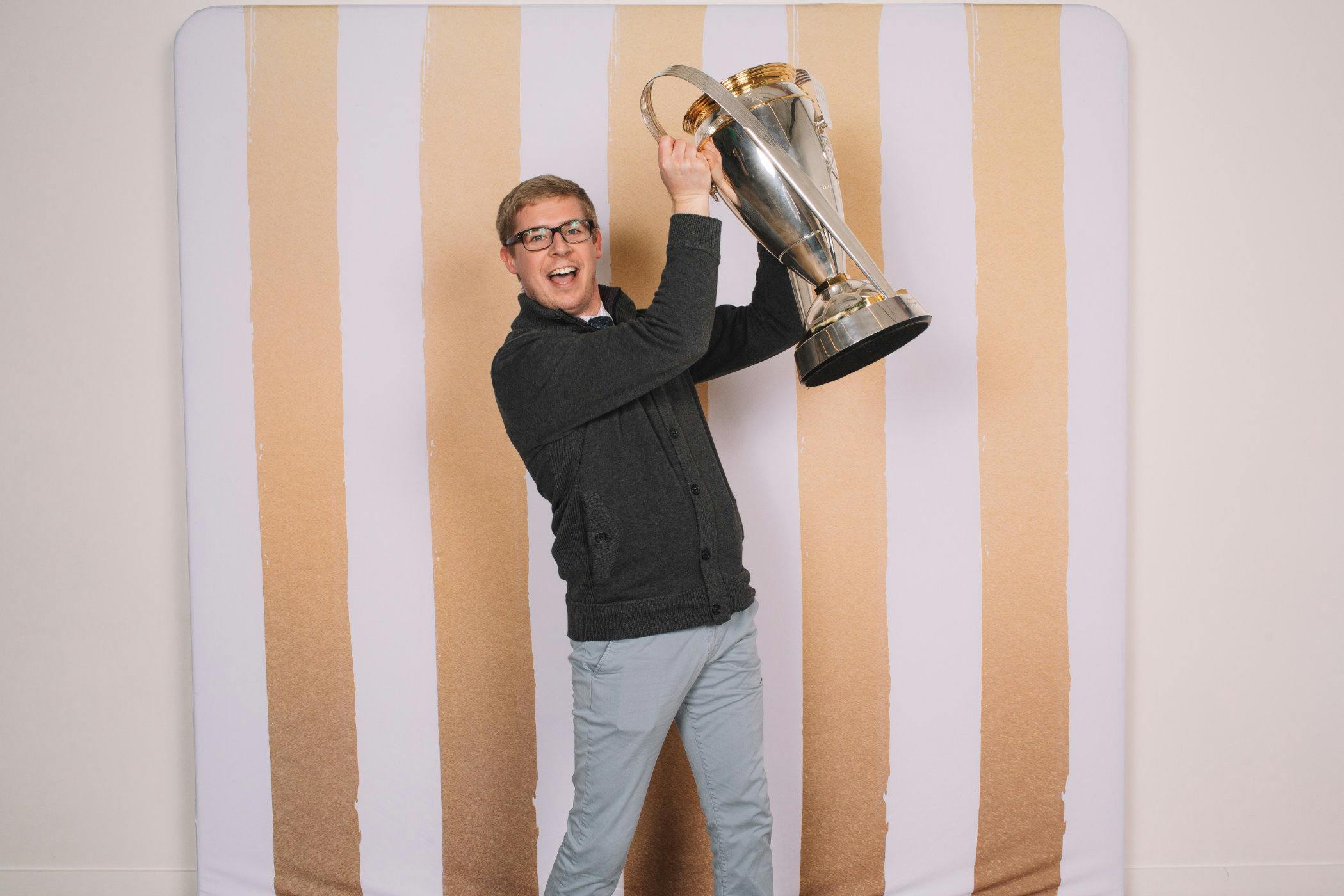 Chris Rue from the Seattle Sounders holding large trophy