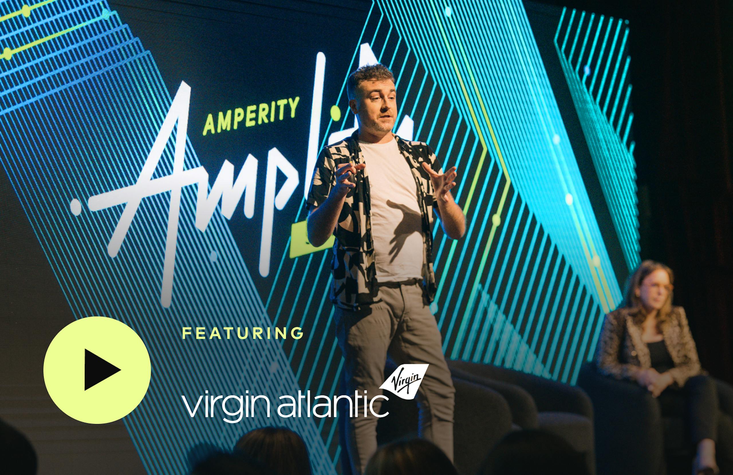 Tom Barber, Head of Data at Virgin Atlantic, standing onstage at Amplify Summit. 