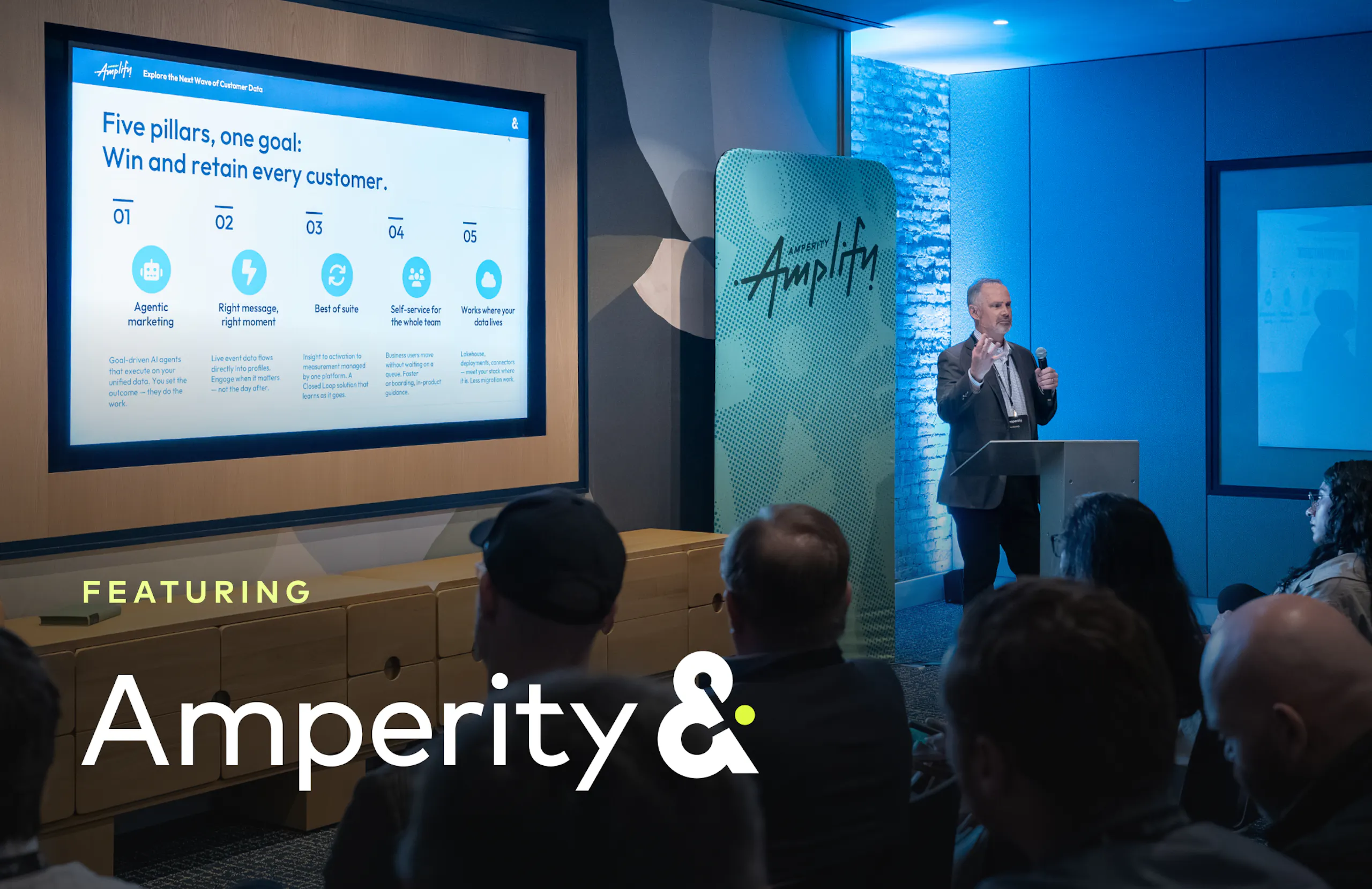 John Grundy at a podium presently the product roadmap at Amplify 2026.