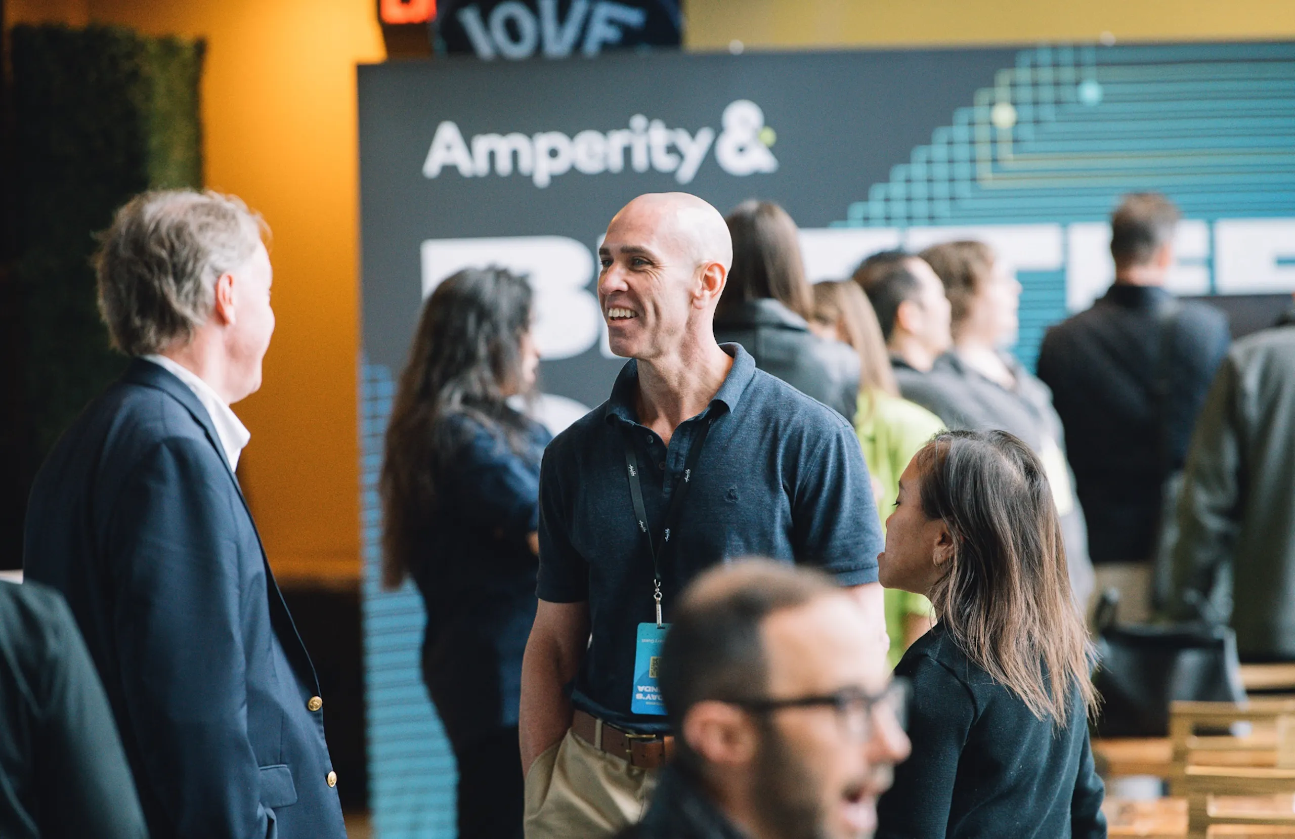 Attendees mingling at an Amplify conference.