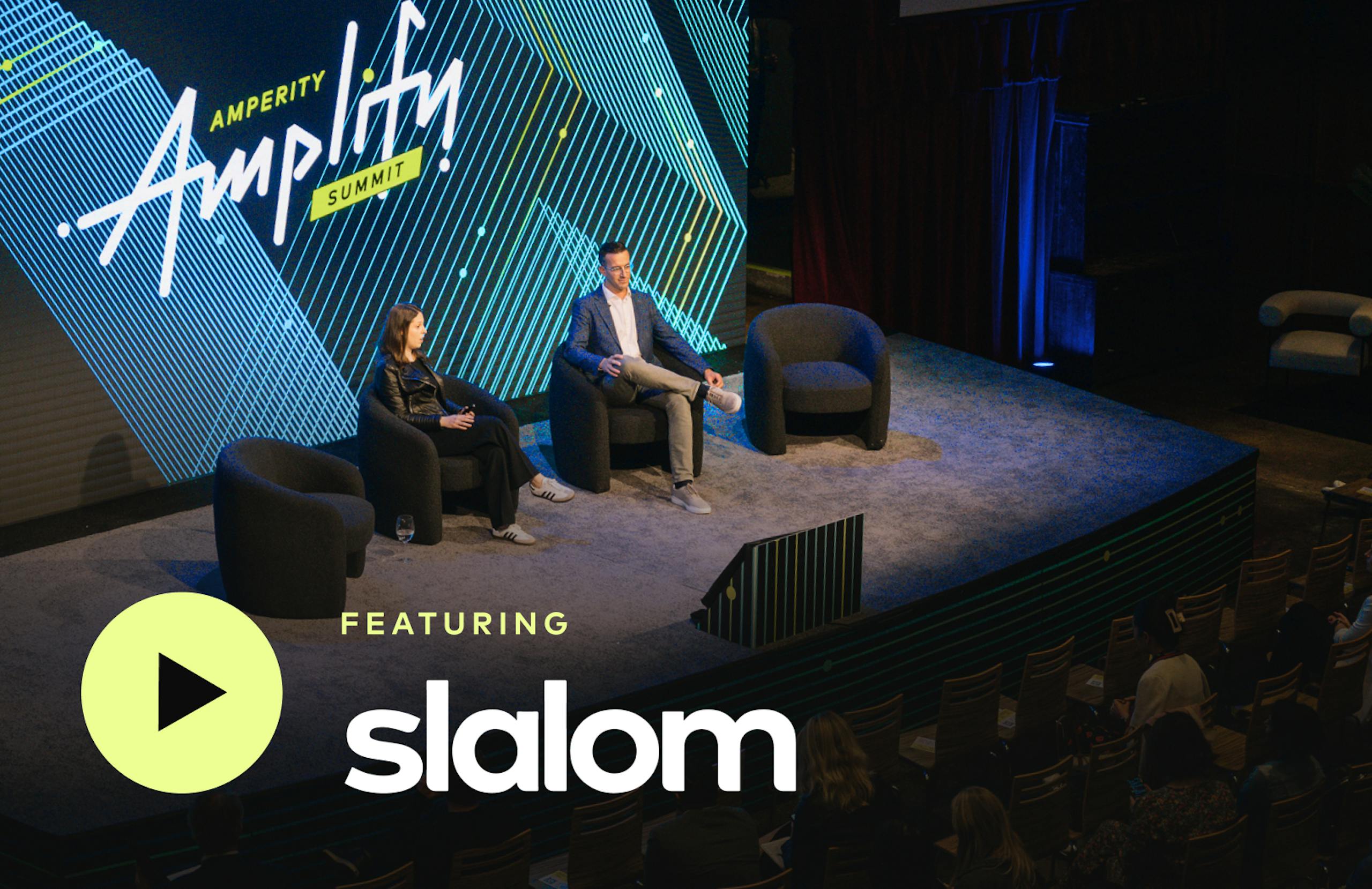 Joyce of Amperity and Logan of Slalom sitting onstage at Amplify Summit.