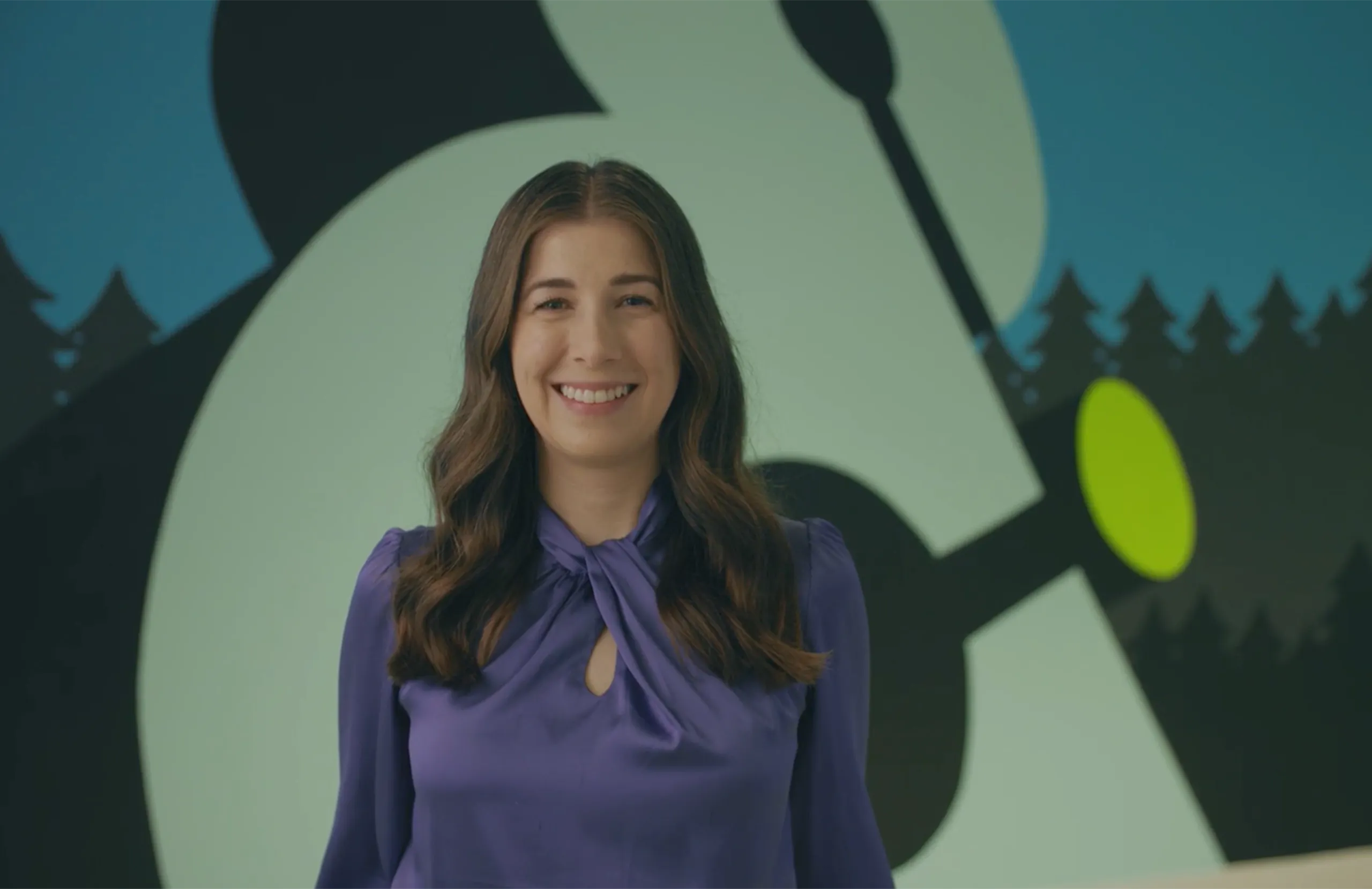 Grace Metzger standing against an Amperity logo mural 